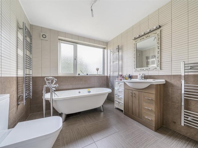 The main house bathroom includes a free standing bath and separate walk-in shower cubicle.