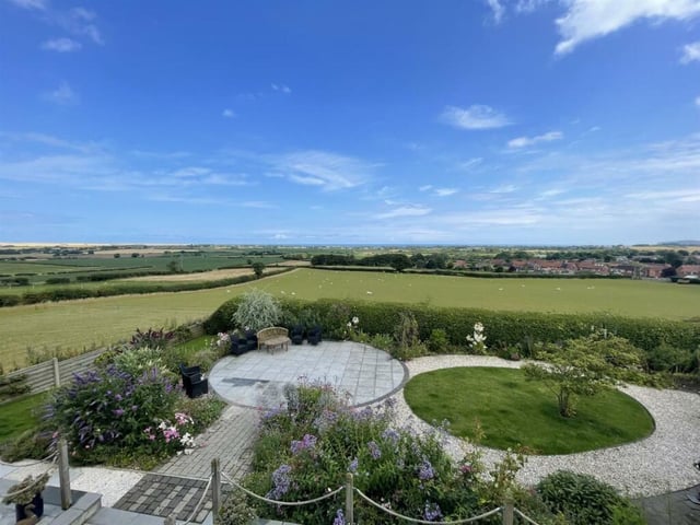 Landscaped gardens and stunning views that stretch for miles.
