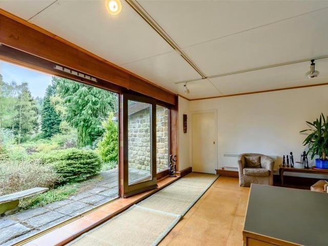 Entertaining is made easy in summer by sets of French doors in the sitting room and the annexe, that open to patio areas fronting the leafy gardens.
