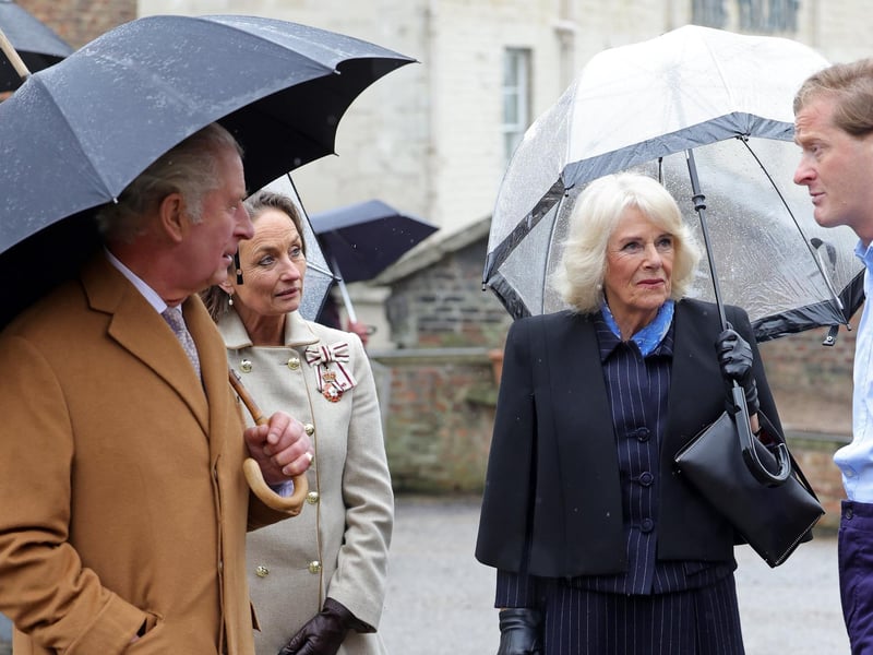 King Charles III and Camilla, Queen Consort talk to the local staff at Talbot Yard.