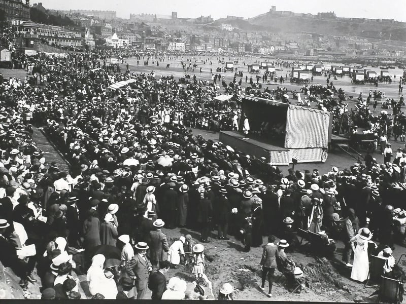 Crowds watch Pierrots performing on a stage on the beach at Scarborough,, 1913, with the castle in the background. (Photo by Hulton Archive/Getty Images)
