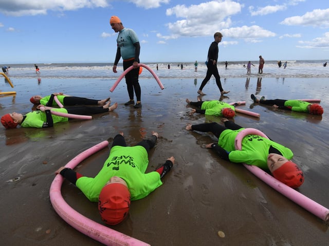 The children learning what to do before they take to the water.