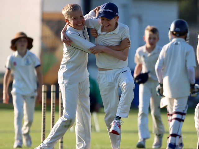 Bridlington Under-13s celebrate taking a wicket.