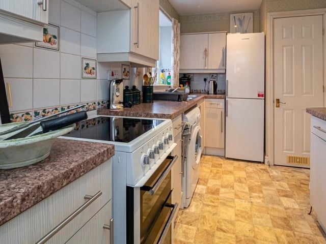 The kitchen has fitted units and a feature bay window.