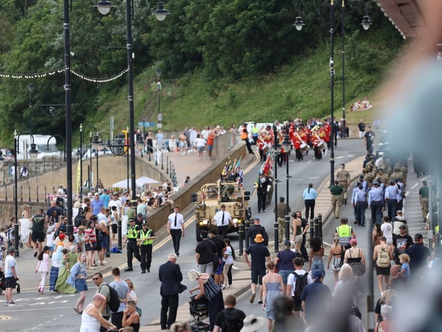 A jeep makes its way to the seafront.