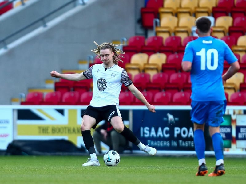 Athletic's defender Kieran Burton looks to get the ball clear.