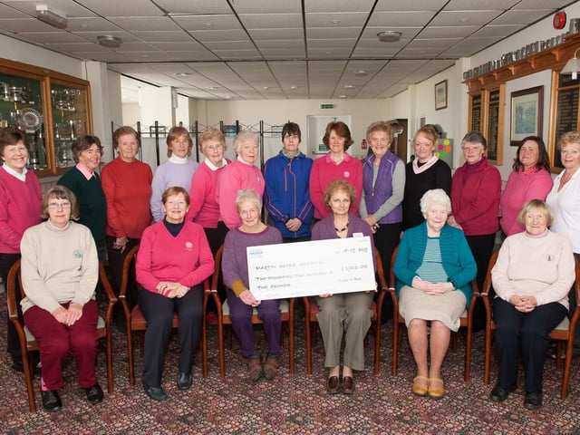 Flamborough Golf Club's ladies section hands over a cheque to charity in 2015.