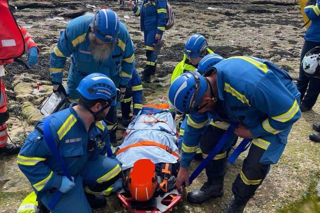 Coastguards team up to help a woman who slipped and broke an ankle at Filey Brigg.