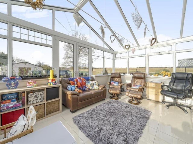 The conservatory is another versatile room, and has French doors leading outside.