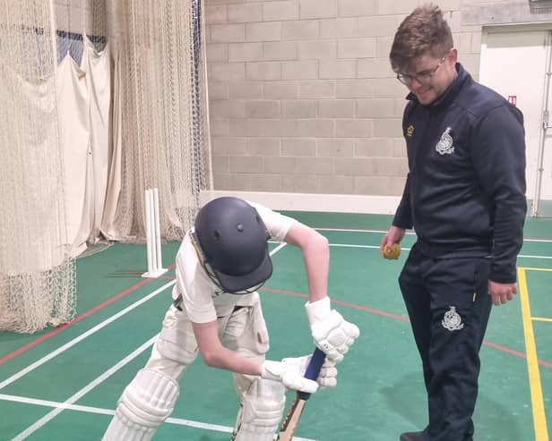 Alfred Denton gets batting coaching from Archie Hammond