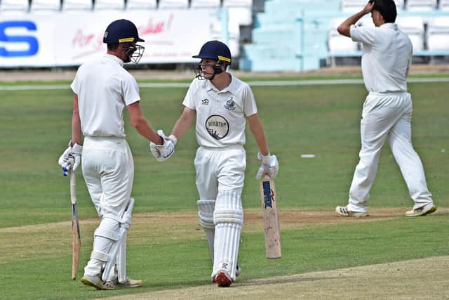 Brad Milburn congratulate Ben Squires on reaching his half century, he went on to hit a century. Photo by Simon Dobson