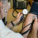 File photo of a GP checking a patient's blood pressure.
