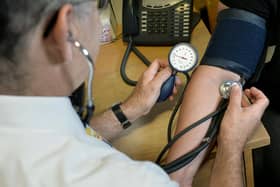 File photo of a GP checking a patient's blood pressure.