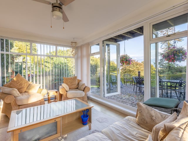 The conservatory has double doors out to a cobbled terrace.