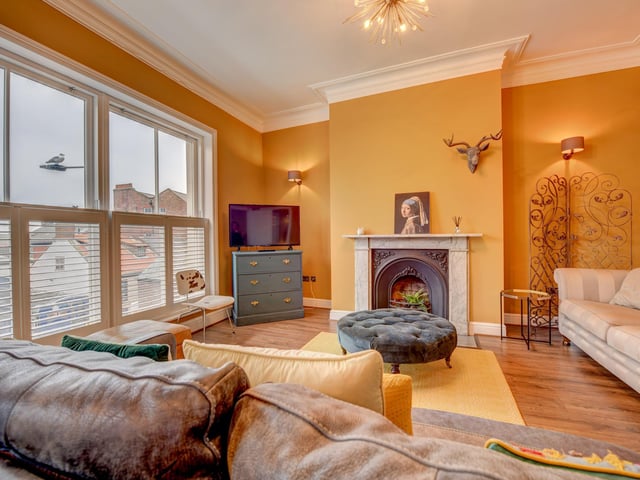The second floor lounge with snug has a feature fireplace and window shutters.