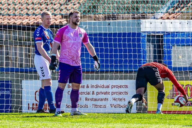 Whitby keeper Shane Bland and defender Alex Nelson look on in despair after Hyde level the scores. Photo by Brian Murfield
