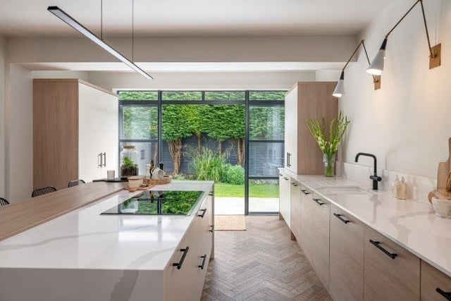The high spec kitchen with island and breakfast bar has a doorway out to the garden.