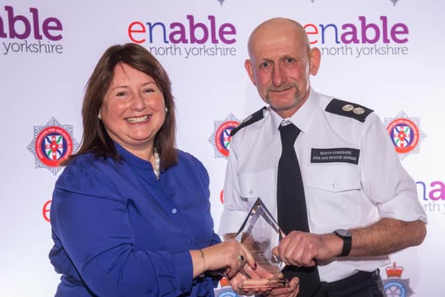 Mr Cossins receives his award from North Yorkshire Police Fire and Crime Commissioner Zoe Metcalfe