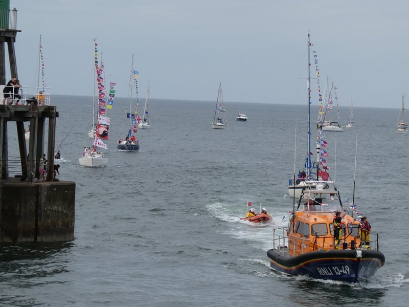 Whitby lifeboat leads the regatta sail past into the harbour.