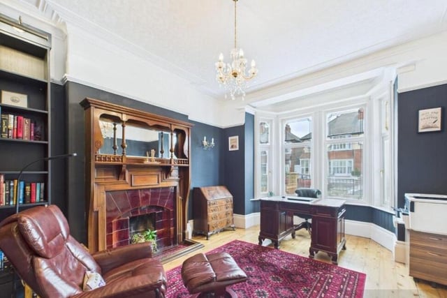 A second large reception room with feature fireplace and fitted bookshelves.