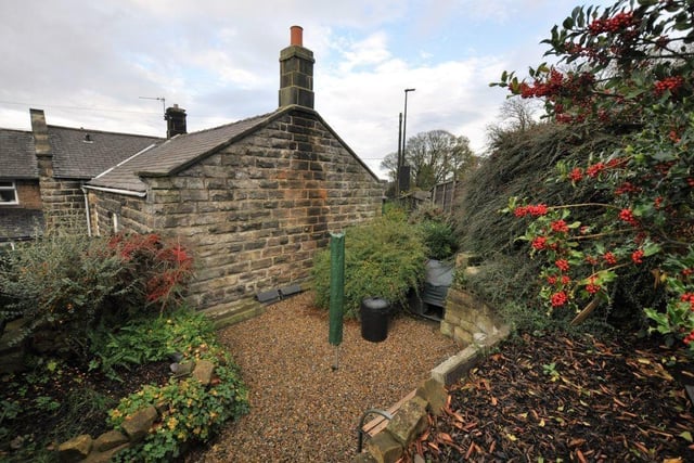 A courtyard leads to a tiered garden at the rear of the property.
