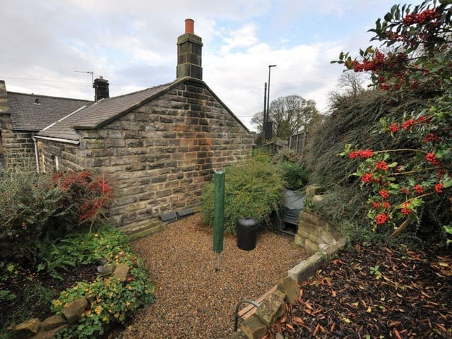 A courtyard leads to a tiered garden at the rear of the property.