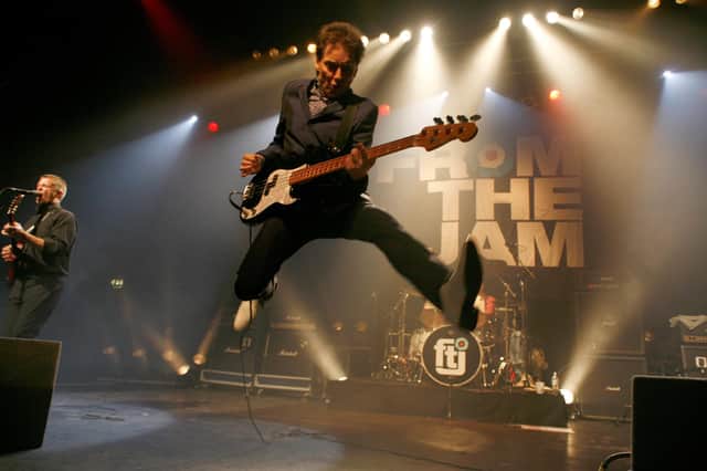 From The Jam's Bruce Foxton gives his trademark scissor jump. Photo by Gary Clark.