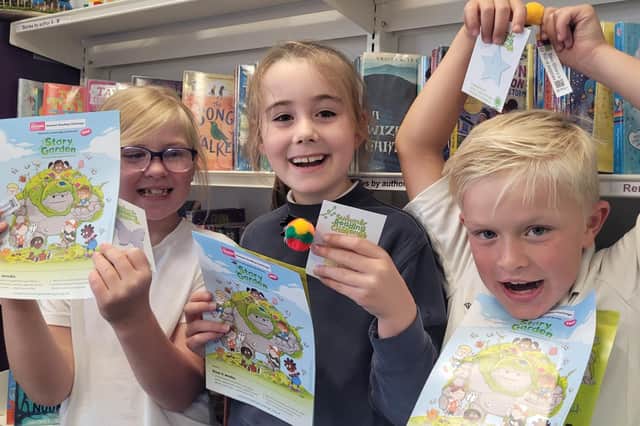 From left, Dara, Ayda and Teddy with Summer Reading Challenge leaflets and stickers.