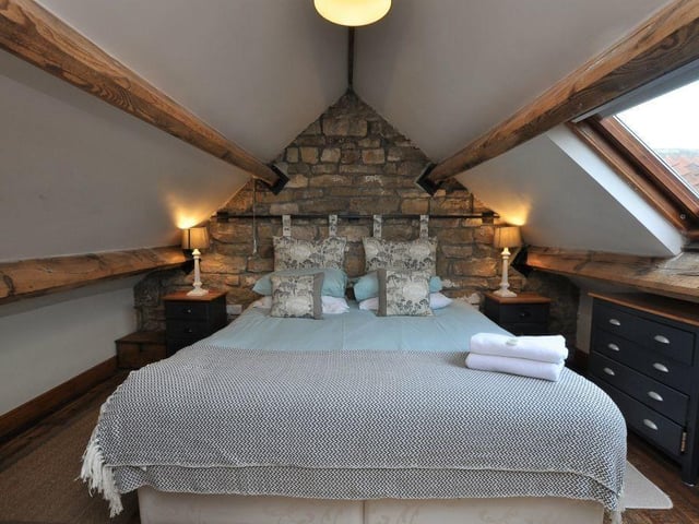 The second double bedroom, with a feature exposed stone wall, has a velux window overlooking stunning rural surroundings.