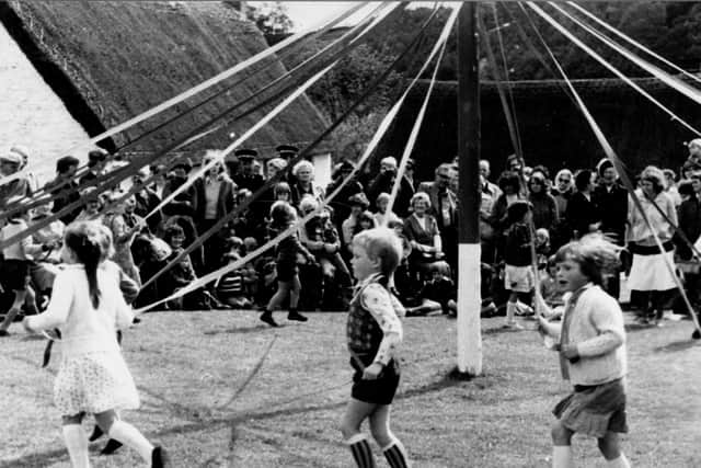 Children Maypole dancing.