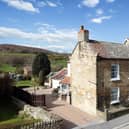 The village property has a lovely location with open countryside to the rear.