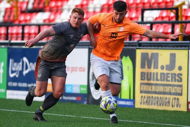 Edgehill, orange shirt, battle it out with Amotherby & Swinton. PHOTO: ZACH FORSTER