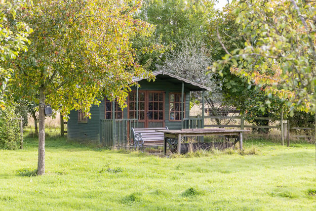 The extensive gardens include this summer house.