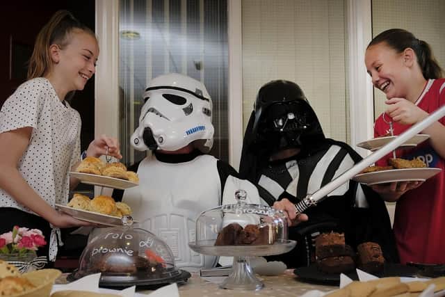 Imperial forces drop in for afternoon tea..Abbie Drydale and Kelsey McGough offer cakes to the visitors.