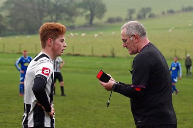Scarborough referee John Chalk dishes out a card during Saturdays clash between Newlands and Sleights