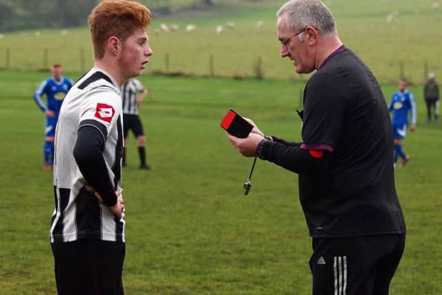 Ref John Chalk dishing out a yellow card