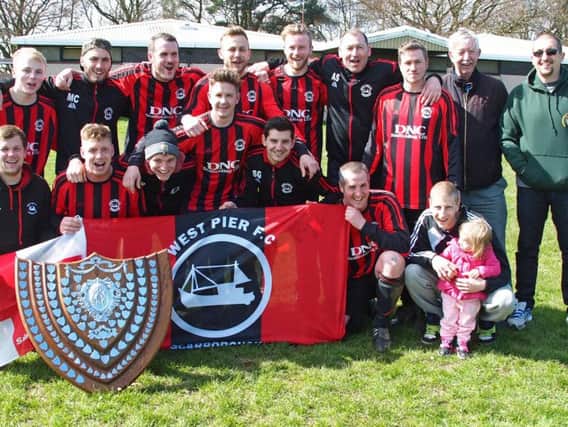 West Pier show off their league shield from last season