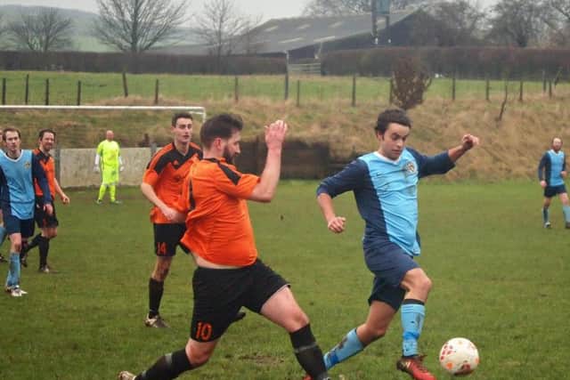 Edgehill, orange kit, in action against Whitby Fishermen