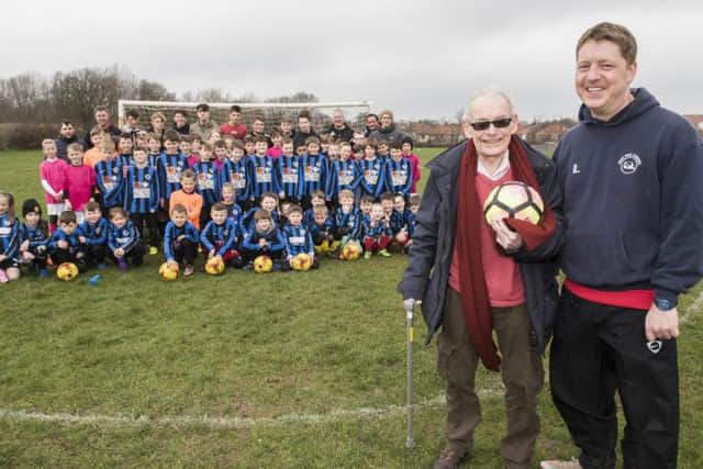 Cllr David Billing, left, and West Pier Juniors chairman Ian Louth with club members at Northstead School