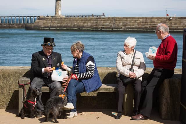 Tourists and goths enjoy fish and chips at Whitby Goth Weekend.  Friday 21 April 2017. w171605k
 Picture: Ceri Oakes