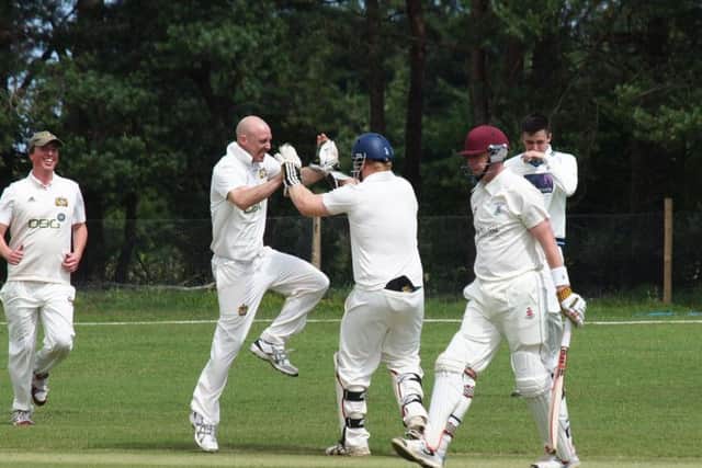Paul Kinghorn celebrates claiming a wicket for Heslerton in their defeat at home to Seamer