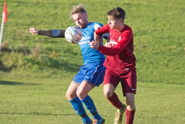 Traf and Angel battle for the ball