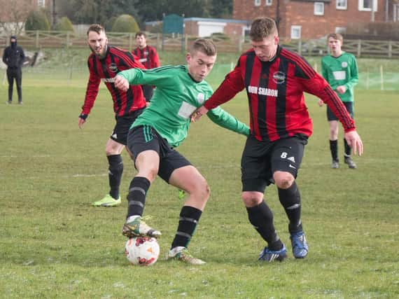Sleights' Charlie Paterson is pressed by Will Jenkinson of West Pier. Pictures by Steve Lilly.