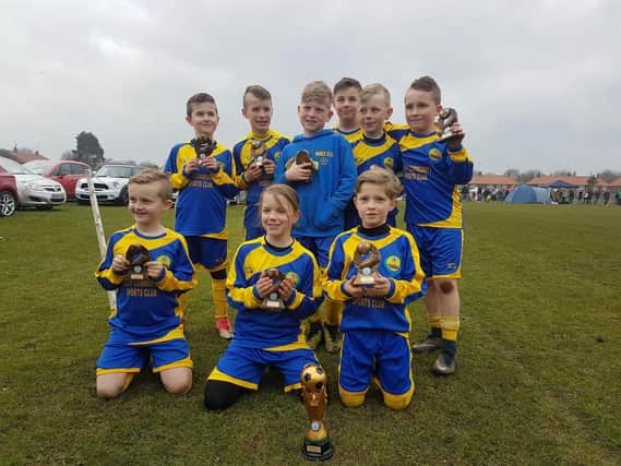 Filey Holt Under-Nines show off their silverware at the Filey Cup