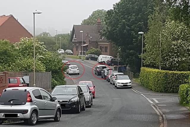Cars parked too closely to allow for buses to pass