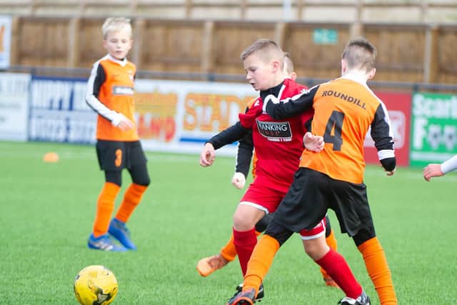 The two sides battle for the ball