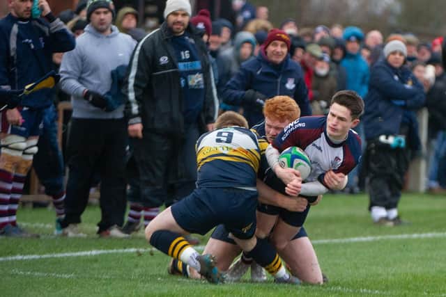 Two Bridlington players halt a Jonty Holloway charge