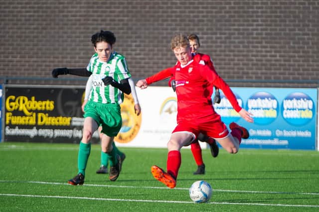 A Scarborough Athletic player lets fly with an effort on goal