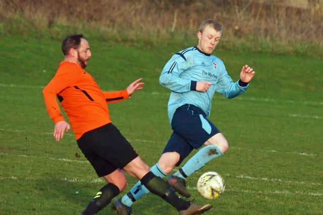 Liam Cooper clears for Edgehill under pressure from Seamer's Danny Glendinning