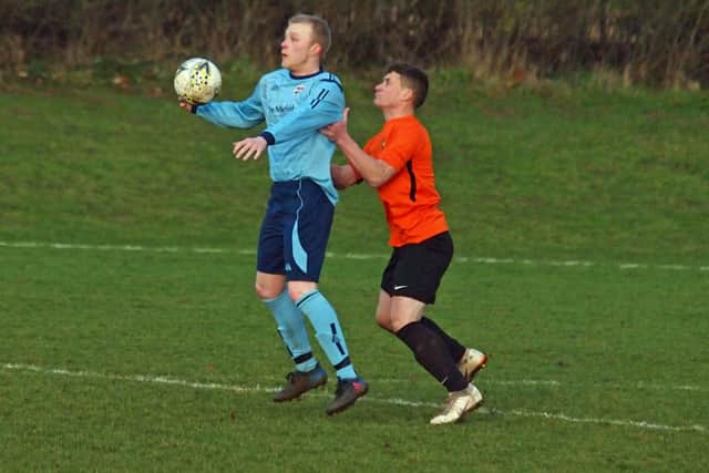 Edgehill's Ricky Nock tries to hold up Danny Glendinning